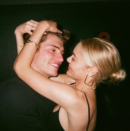 Gregg Sulkin held his girlfriend, Michelle Randolph, in his arms as they posed for a picture.